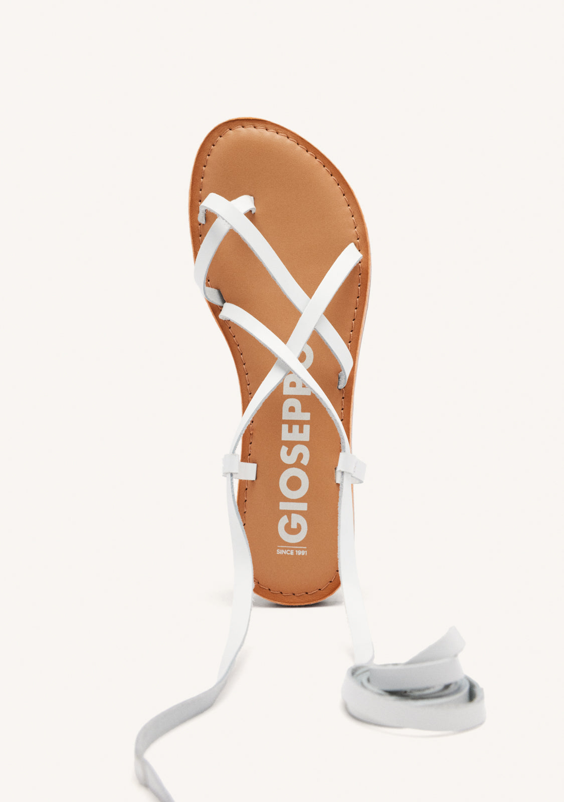 Lussat sandals with thin tan straps to tie around the leg